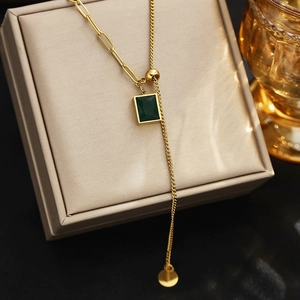 Close-up of emerald green zircon pendant on adjustable gold necklace with pull-buckle