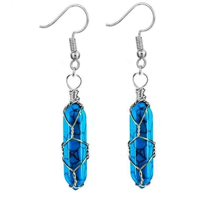Macro shot of copper wire wrapped hexagonal blue turquoise crystal drop earrings