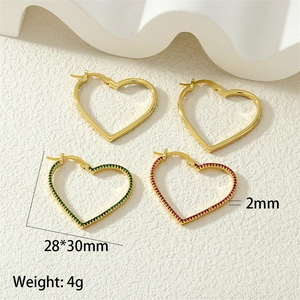Detailed view of hollow heart earrings in gold finish with crystal accents, size 28x30mm
