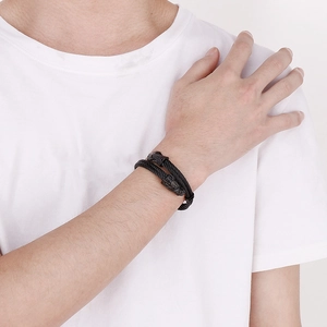 Close-up of punk dragon head double-wire woven stainless steel bracelet on male wrist