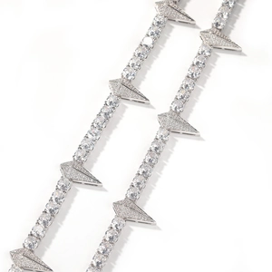 Macro view of silver tennis chain with sparkling zircon stones and triangular spike details