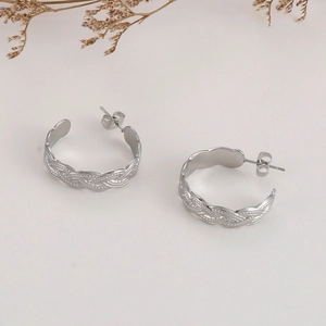 Macro detail of silver twisted texture stainless steel hoop earrings with stud back