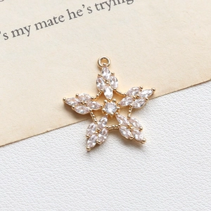 Close-up of star-shaped gold pendant with marquise-cut cubic zirconia for DIY jewelry