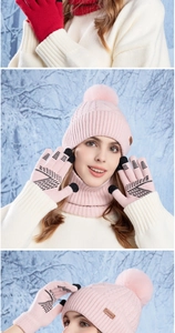 Detail of pink knitted hat with pom-poms, neck warmer and touchscreen gloves set