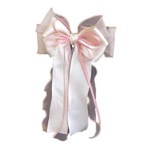 Elegant oversized white jasmine mesh bow hair clip with multi-layer silk ribbons and long tassels