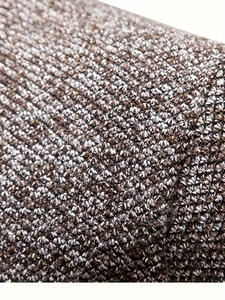 Close-up detail of heavy knit wool fabric in dark brown and white blended yarn