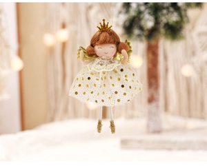 Macro detail of Christmas angel doll hanging ornament with gold crown and sequin mesh dress