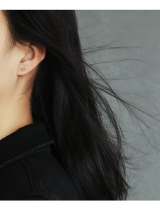 Close-up of geometric square blue zircon stud earring worn on model for minimalist style