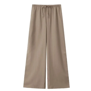 Detail of khaki linen wide-leg trousers featuring elastic drawstring waist and straight cut