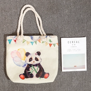 Canvas tote bag with cute cartoon panda print and thick cotton rope handles on grey background