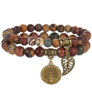 Detailed close-up of double-layer beaded bracelet with tree of life and leaf charms