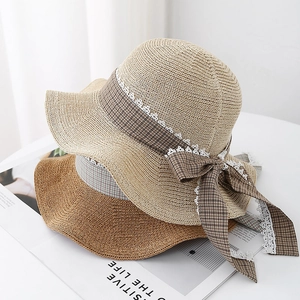 Handwoven straw beach hats with plaid ribbon bows in khaki and brown for summer sun protection