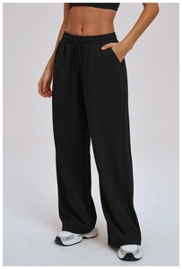 Close-up of black wide-leg sweatpants with drawstring waist and side pockets for casual wear