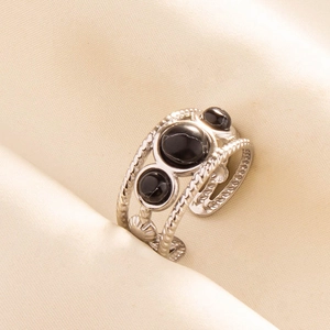 Detailed macro view of adjustable silver 304 stainless steel ring with black marble stone