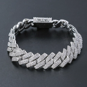 Macro view of silver Cuban link bracelet with micro-pave zircons on reflective surface