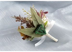 Detail of boutonniere back showing green fixing clip and realistic olive leaves