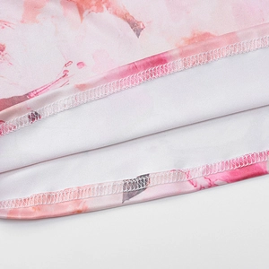 Detailed view of pink marble print fabric edge with professional white overlock stitching