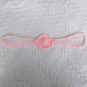 Detailed view of handmade pink crochet funny nose prop for Halloween party costume