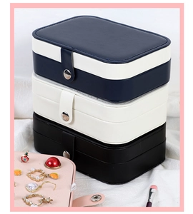 Close-up of portable leather jewelry boxes in multiple colors with snap button closure