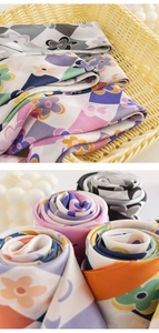 Detail of colorful geometric flower silk scarves neatly folded in a woven bamboo basket