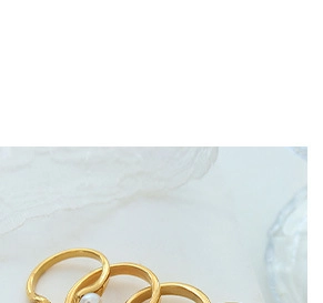 Detailed close-up of a gold-plated ring set with an elegant white freshwater pearl