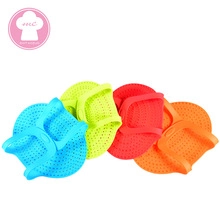 Set of four colorful silicone shark-shaped oven mitts with non-slip texture detail