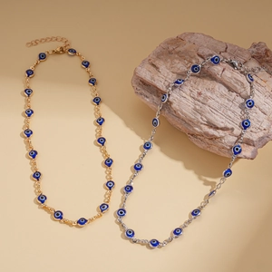 Detail of gold and silver Evil Eye beaded necklaces with Nazar charms on wooden blocks