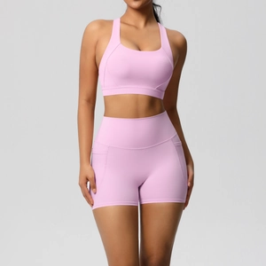 Detail of pink sports bra and high-waist shorts with functional side pockets