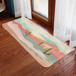 Detail view of desert landscape rug with cactus on dark wood floor and soft natural light