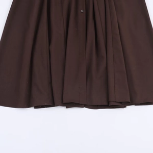 Fashionable dark brown button-down shirt dress with a belt and pleated hem detail