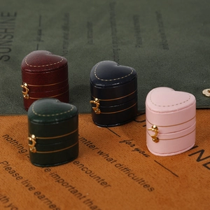 Elegant heart-shaped mini jewelry boxes in four colors with secure gold metal clasps