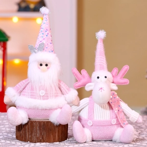 Detail of pink and white plush Santa and Reindeer dolls with sequins on wooden base