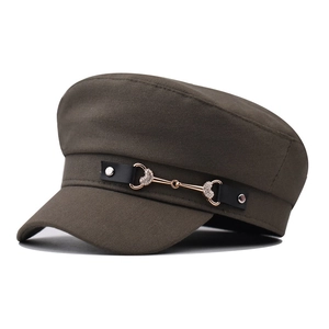 Detail of army green baker boy hat with rhinestone horsebit and leather strap trim