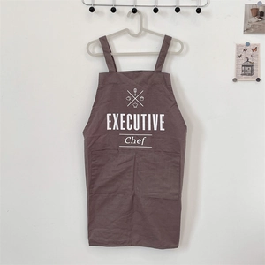 Close-up of brown cotton linen apron with Executive Chef print and large front pockets