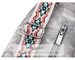 Detail of adjustable metal buckle and bohemian woven strap on grey fabric bag