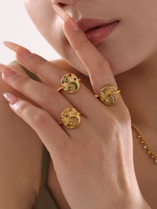 Detail of 18K gold plated rings set with star, moon, and devil eye zircon motifs