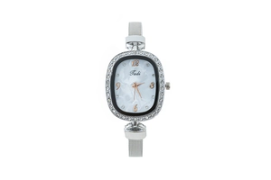 Close-up of the elegant oval silver watch case with rhinestone bezel and marble dial