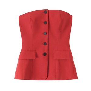 Detail of red tube top featuring black buttons and symmetrical decorative faux pockets