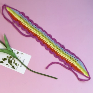 Close-up of handmade crochet headband with colorful stripes and purple scallop edges
