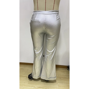 Detail showing the shiny metallic silver fabric and back cut of flared trousers