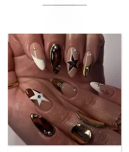 Detailed macro of tortoise shell almond press-on nails with stars and pearl accents