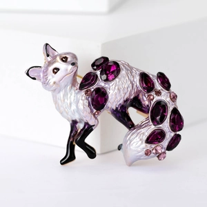 Detailed macro view of an alloy fox brooch featuring purple crystals and white enamel