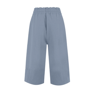 Close-up of the elastic waistband and textured linen fabric on blue wide-leg pants