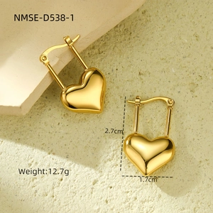 Detailed view of gold heart earrings with dimensions 2.7cm by 1.7cm on a neutral background
