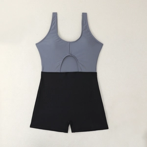 Detail of two-tone one-piece swimsuit with cutout and black boyshorts bottom