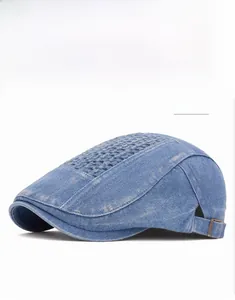 Detail of blue denim flat cap featuring checkered hollow weave and adjustable strap buckle