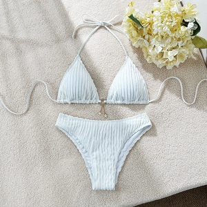 Detailed view of light blue bikini featuring rib-textured fabric and gold star pendant