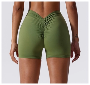 Macro detail of high-waist olive green yoga shorts with V-shaped back and ruched booty lifting seam