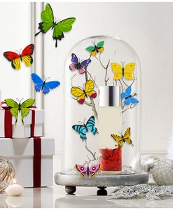 Close-up of colorful butterfly stickers on a glass cloche with wooden base for home decor