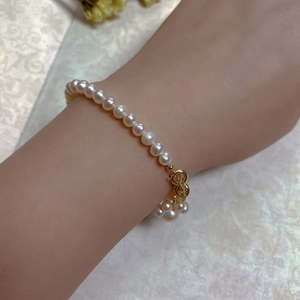 Close-up of 14K gold-filled clasp and round pearls on a vintage style bracelet
